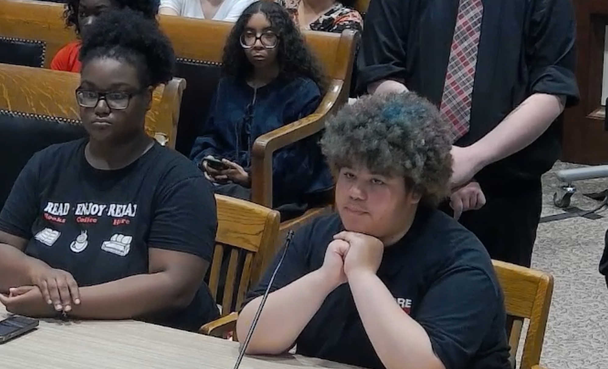 Two youth advocates with the organization More Than Words testify on in the Massachusetts state Legislature in support of a bill of rights for children in foster care on July 8. 2025.