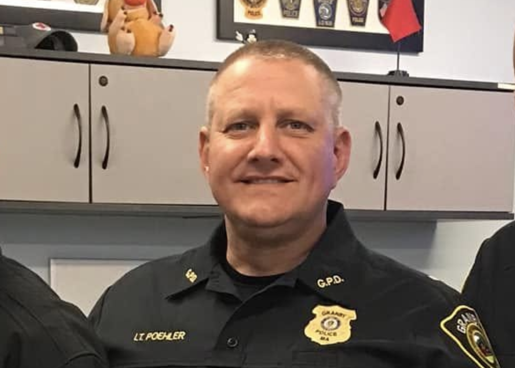 Now-retired Granby Police Lt. Gary Poehler smiles at the camera in his uniform in April 2022.